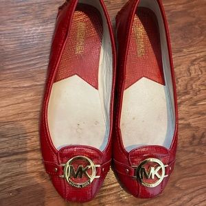 Michael Kors red shiny flats with gold logo and soft soles